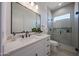 Stylish bathroom with quartz countertop, sleek fixtures, and a contemporary glass-enclosed shower at 1250 E Smokehouse Trl, Phoenix, AZ 85085