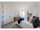Cozy bedroom showcasing neutral tones, plush carpeting, a comfortable bed, and natural light from the large window at 1250 E Smokehouse Trl, Phoenix, AZ 85085