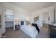 Bright bedroom showcasing plush carpeting, neutral colors, a comfortable bed, and access to a walk-in closet at 1250 E Smokehouse Trl, Phoenix, AZ 85085