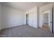 Carpeted bedroom with closet and access to another room at 1250 E Smokehouse Trl, Phoenix, AZ 85085