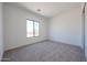 Bright, empty bedroom with neutral carpet, window, and clean, modern lines at 1250 E Smokehouse Trl, Phoenix, AZ 85085