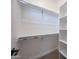 Walk-in closet featuring ample shelving and hanging space, designed to maximize storage and organization at 1250 E Smokehouse Trl, Phoenix, AZ 85085