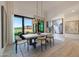 Bright dining room featuring a modern light fixture, large windows and access to the backyard at 1250 E Smokehouse Trl, Phoenix, AZ 85085