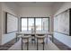 Bright dining room featuring hardwood floors, abstract art, dining table, and sliding glass doors with views at 1250 E Smokehouse Trl, Phoenix, AZ 85085