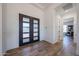 Bright foyer with stylish entry door, neutral decor, and wood-look tile floors at 1250 E Smokehouse Trl, Phoenix, AZ 85085