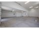 Spacious, bright garage featuring a clean concrete floor, white walls, and multiple overhead lights at 1250 E Smokehouse Trl, Phoenix, AZ 85085