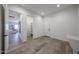 Hallway featuring an open entrance into a living area, tile floors, and modern white walls at 1250 E Smokehouse Trl, Phoenix, AZ 85085