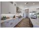 White kitchen features a stainless hood, range, island and bright counter tops at 1250 E Smokehouse Trl, Phoenix, AZ 85085