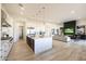 Stylish open-concept kitchen and living area with a large island, modern fireplace, and comfortable seating at 1250 E Smokehouse Trl, Phoenix, AZ 85085