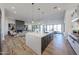 Open-concept kitchen with island, stone countertops, and living room views at 1250 E Smokehouse Trl, Phoenix, AZ 85085
