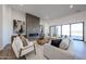 Bright living room features a sleek fireplace, stylish decor, and expansive sliding glass doors at 1250 E Smokehouse Trl, Phoenix, AZ 85085