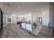 Expansive open-concept living space with wood tile flooring connecting the living room to the kitchen at 1250 E Smokehouse Trl, Phoenix, AZ 85085