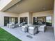 Inviting covered outdoor patio with modern patio furniture and views of interior through sliding glass doors at 1250 E Smokehouse Trl, Phoenix, AZ 85085