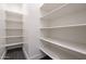 Spacious walk-in pantry featuring tiled floors and ample shelving for storage in this home at 1250 E Smokehouse Trl, Phoenix, AZ 85085