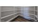 Interior view of a walk-in pantry with open shelving and wood-look flooring at 1250 E Smokehouse Trl, Phoenix, AZ 85085