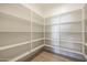 Spacious walk-in pantry featuring wood floors and ample shelving for storage in this home at 1250 E Smokehouse Trl, Phoenix, AZ 85085