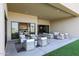 Covered patio featuring comfortable seating areas, artificial turf, and multiple entry points at 1250 E Smokehouse Trl, Phoenix, AZ 85085