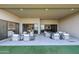 Covered patio with comfortable seating areas, artificial turf, and seamless indoor/outdoor living at 1250 E Smokehouse Trl, Phoenix, AZ 85085