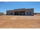 Contemporary home featuring a sleek, flat roofline, large windows, and desert landscaping under a clear blue sky at 1250 E Smokehouse Trl, Phoenix, AZ 85085