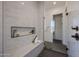 Modern tiled shower with a glass door, bench seat, and built-in shelving at 1250 E Smokehouse Trl, Phoenix, AZ 85085