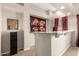 Cozy bar area featuring granite countertop and hot air balloon art at 13313 W Palo Verde Dr, Litchfield Park, AZ 85340