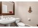 Bathroom with framed mirror, white fixtures, and decorative wall piece at 13313 W Palo Verde Dr, Litchfield Park, AZ 85340