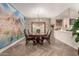 Elegant dining room with stylish furniture, modern lighting, and a decorative wall mural at 13313 W Palo Verde Dr, Litchfield Park, AZ 85340