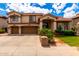 Charming two-story home featuring a red tile roof, arched entryway, and well-manicured landscaping at 13313 W Palo Verde Dr, Litchfield Park, AZ 85340