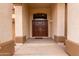 Close up of grand double door entrance with an arched transom window and sturdy sidelights at 13313 W Palo Verde Dr, Litchfield Park, AZ 85340