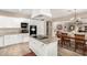 Bright kitchen featuring white cabinetry, granite countertops, and stainless steel appliances and center island cooktop at 13313 W Palo Verde Dr, Litchfield Park, AZ 85340