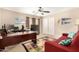 Office space featuring a ceiling fan, a desk, and a red couch at 13313 W Palo Verde Dr, Litchfield Park, AZ 85340