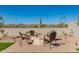 Inviting backyard featuring a charming fire pit area with chairs, perfect for evening gatherings at 13618 W Phacelia Ln, Peoria, AZ 85383