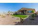 Spacious backyard featuring low maintenance gravel landscaping and a covered patio, perfect for outdoor enjoyment at 13618 W Phacelia Ln, Peoria, AZ 85383