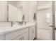 Bright bathroom featuring double sinks, a large mirror and modern hardware at 13618 W Phacelia Ln, Peoria, AZ 85383