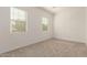 Well lit room with neutral colored carpet and 2 bright windows at 13618 W Phacelia Ln, Peoria, AZ 85383