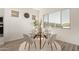 Bright dining area with a modern glass table and stylish seating, perfect for intimate meals at 13618 W Phacelia Ln, Peoria, AZ 85383