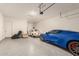 Spacious three car garage showcasing epoxy floors and ample room for vehicles and storage at 13618 W Phacelia Ln, Peoria, AZ 85383
