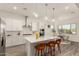 Open-concept kitchen with a central island, pendant lighting, and a view to the dining area at 13618 W Phacelia Ln, Peoria, AZ 85383