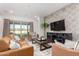 Inviting living room features a modern design, tile floors, and ample natural light from sliding glass doors at 13618 W Phacelia Ln, Peoria, AZ 85383