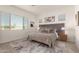 Stylish main bedroom with a decorative rug, window and a large cozy bed at 13618 W Phacelia Ln, Peoria, AZ 85383