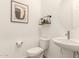 Tastefully designed powder room with a pedestal sink, round mirror, and elegant wall decor at 13618 W Phacelia Ln, Peoria, AZ 85383