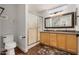Bathroom features a double vanity, granite countertop, framed mirror, and glass-enclosed shower at 1474 E Riviera Dr, Chandler, AZ 85249