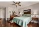Comfortable bedroom featuring a ceiling fan, wooden dresser, and Southwestern artwork above the bed at 1474 E Riviera Dr, Chandler, AZ 85249