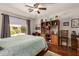 Bedroom featuring a ceiling fan, large window, and a built-in bookcase at 1474 E Riviera Dr, Chandler, AZ 85249
