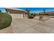 Long driveway leading to a two car garage, complemented by desert landscaping at 1474 E Riviera Dr, Chandler, AZ 85249
