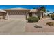 Charming single-level home featuring a two-car garage and desert landscaping at 1474 E Riviera Dr, Chandler, AZ 85249