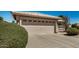 Attached two car garage with a neutral door and beautiful desert landscaping at 1474 E Riviera Dr, Chandler, AZ 85249