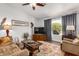 Comfortable living room with hardwood floors, a ceiling fan, and ample natural light at 1474 E Riviera Dr, Chandler, AZ 85249