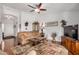 Cozy living room with hardwood floors, neutral-toned furniture and a ceiling fan at 1474 E Riviera Dr, Chandler, AZ 85249