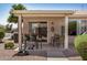 Covered patio with seating, potted flowers, and views of desert landscape, creating an inviting outdoor space at 1474 E Riviera Dr, Chandler, AZ 85249